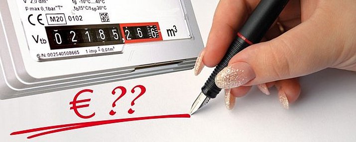 Bild einem Gaszähler und einer schreibenden Hand mit Stift die schreibt: € ???