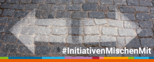 Zwei Pfeile in unterschiedliche Richtungen, die auf Pflaster gemalt sind. Text #InitiativenMischenMit